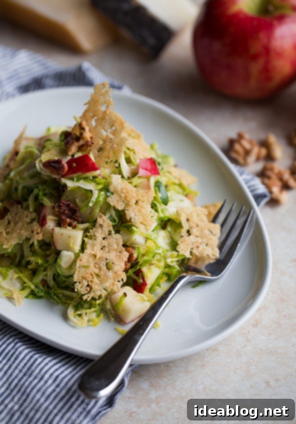 12 Soul-Satisfying Autumn Salads 3 Brussels Sprouts Salad with Apple, Walnuts, and Parmesan-Pecorino Crisps - a delightful fall salad with savory cheese crisps.