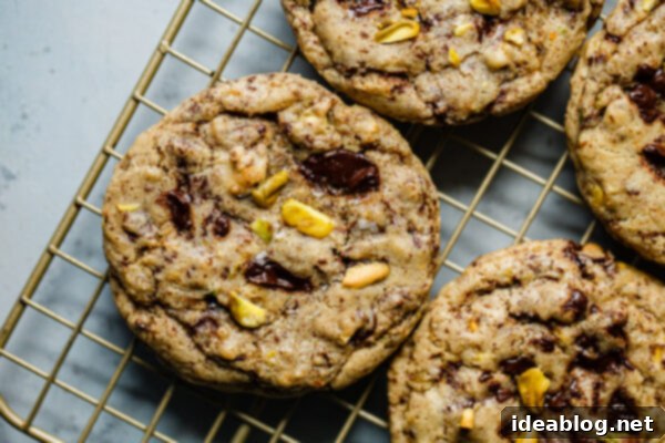 Zesty Orange Pistachio Chocolate Chunk Cookies 13 Orange Pistachio Chocolate Chunk Cookies cooling on a wire rack