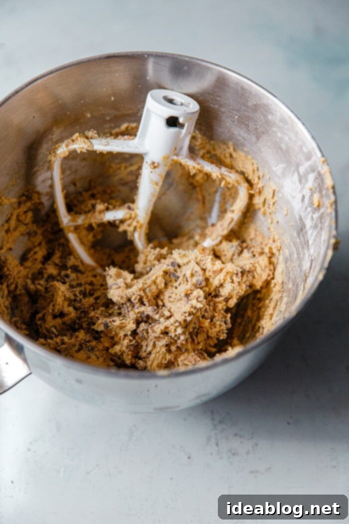 Zesty Orange Pistachio Chocolate Chunk Cookies 3 Cookie dough in a stand mixer bowl, ready for baking.