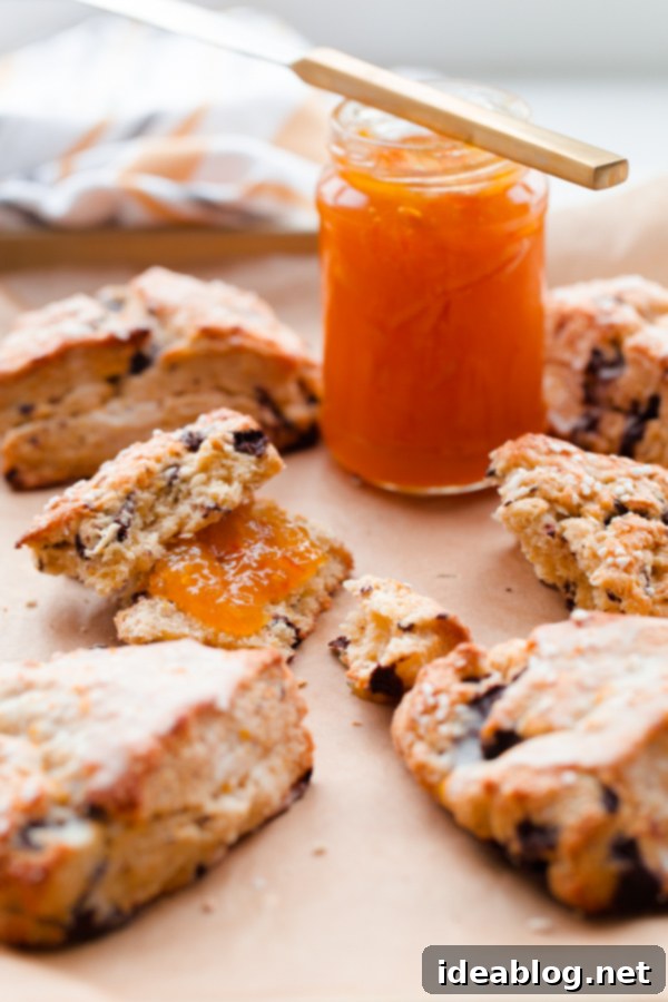 Bright Orange Chocolate Chunk Scones with Zesty Citrus Drizzle 2 Deliciously flaky orange chocolate chunk scones with fresh orange glaze, perfect for breakfast or dessert. This easy cream scone recipe is ready in just 30 minutes!