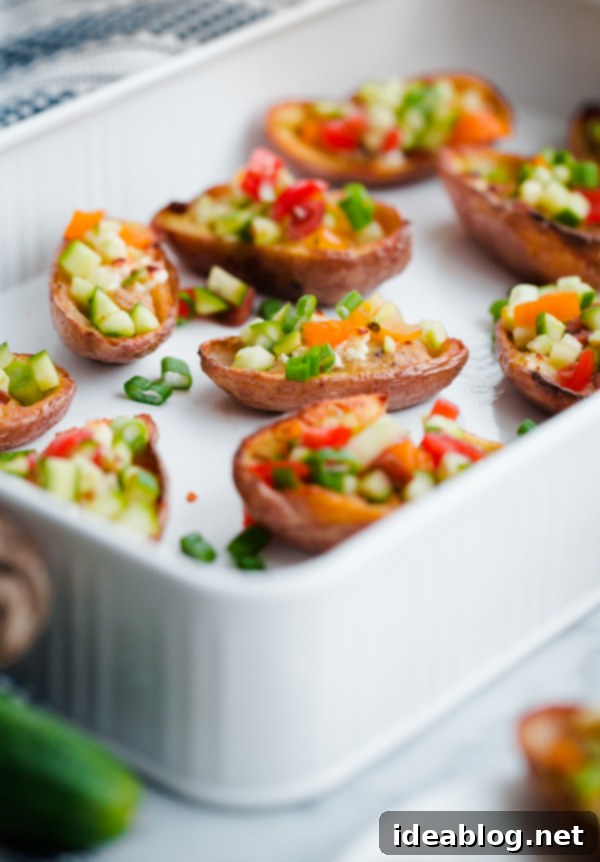 Mediterranean Hummus Potato Boats 4 Greek-Style Potato Skins with Hummus. A HEALTHY and easy potato skin recipe made with hummus, feta, and chopped vegetables - a great party or tailgating appetizer!