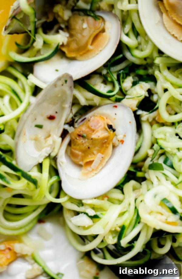 Zucchini Pasta with Garlic Clam Sauce. An EASY, healthy dinner recipe made with zucchini noodles. Less than 250 calories per serving! #abeautifulplate #glutenfree #clam #pasta #zoodles #recipe Delicious Zucchini Pasta with Garlic Clam Sauce, a light and healthy meal