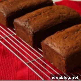 The Ultimate Family Banana Bread 2 Two golden-brown banana bread loaves on a wire cooling rack, ready to be sliced and enjoyed.