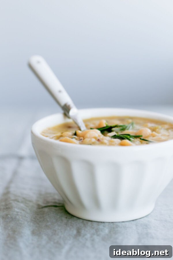 Slow Cooker Cannellini Bean Soup - this EASY crockpot white bean soup is made with dried cannellini beans, fresh rosemary, and other easy to grab ingredients! It comes together quickly and is healthy, filling, and delicious! #cannellini #soup #crockpot #slowcooker #soup #healthy #glutenfree Slow Cooker Cannellini Bean Soup