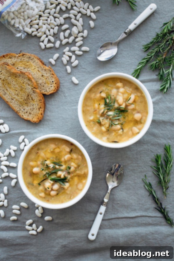 Slow Cooker Cannellini Bean Soup - this EASY crockpot white bean soup is made with dried cannellini beans, fresh rosemary, and other easy to grab ingredients! It comes together quickly and is healthy, filling, and delicious! #cannellini #soup #crockpot #slowcooker #soup #healthy #glutenfree Slow Cooker White Bean Soup with Rosemary