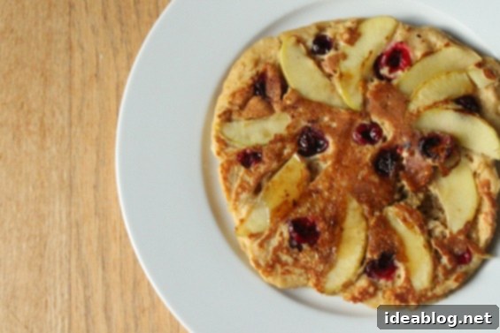 Cranberry Apple Cinnamon Pancakes 2 Delicious stack of Cinnamon Apple Cranberry Pancakes drizzled with maple syrup