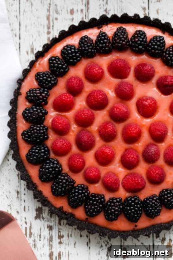 Triple Citrus Tart with Decadent Chocolate Crust and Fresh Berries Triple Citrus Tart with Berries and Chocolate Crust - a stunning dessert featuring zesty blood orange, lemon, and lime curd on a dark chocolate wafer base.