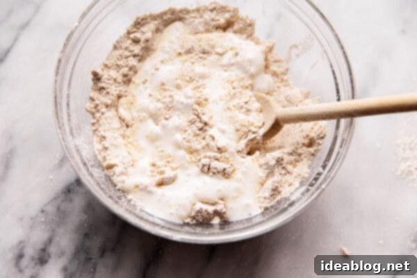 Simple, Wholesome Wheat Biscuits 15 Adding buttermilk to whole wheat biscuit dough mixture.