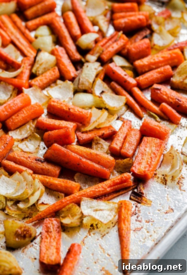 Vegan Garam Masala Carrot Soup. This easy, creamy soup comes together in less than 45 minutes, using just a sheet pan and blender. Roasted Carrots and Onions on Sheet Pan