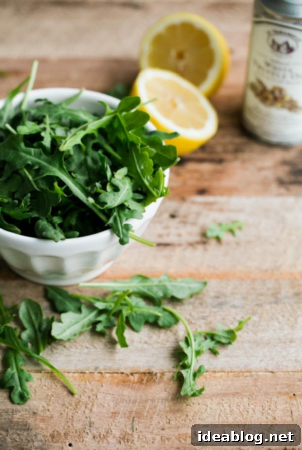 Lemon Truffle Arugula Pizza. A cheese pizza topped with a lemon truffle oil arugula salad! This elegant simple homemade pizza is a crowd favorite!  Arugula Pizza Ingredients