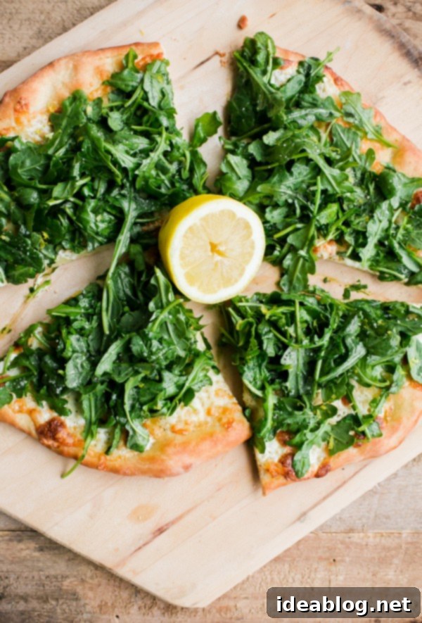 Lemon Truffle Arugula Pizza. A cheese pizza topped with a lemon truffle oil arugula salad! This elegant simple homemade pizza is a crowd favorite!  Lemon Truffle Arugula Pizza