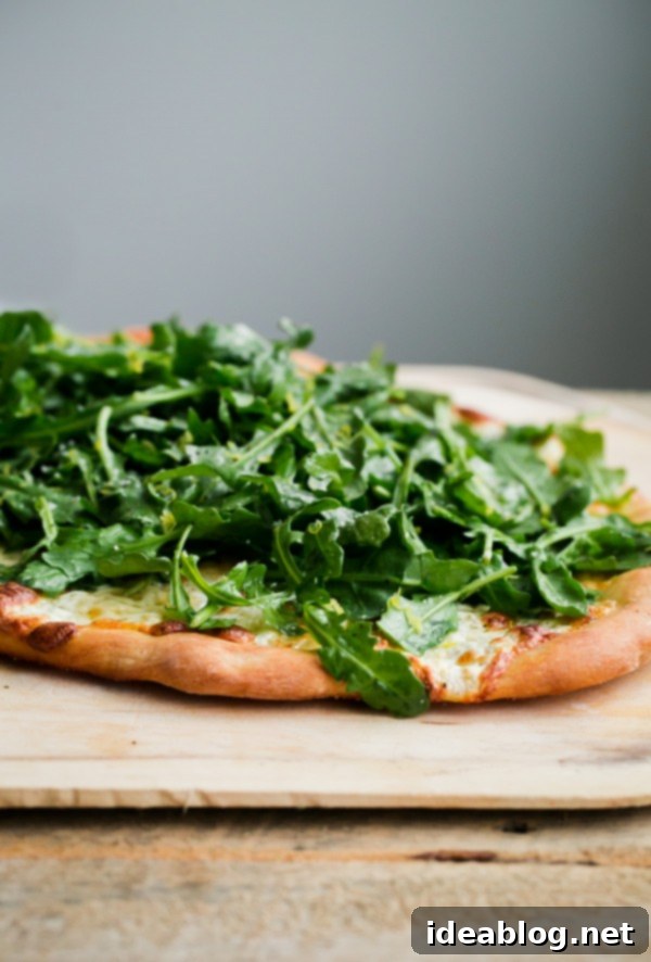 Lemon Truffle Arugula Pizza. A cheese pizza topped with a lemon truffle oil arugula salad! This elegant simple homemade pizza is a crowd favorite!  Lemon Truffle Arugula Pizza