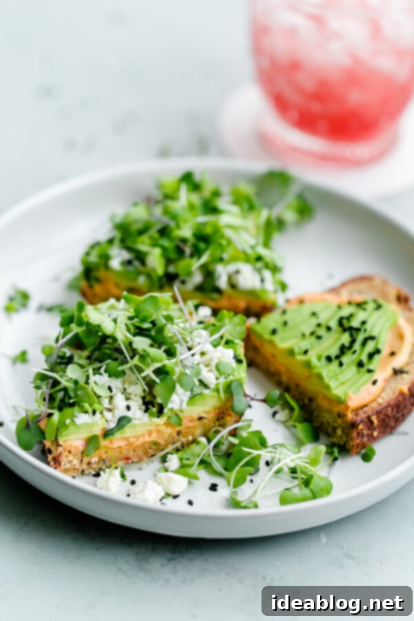 Spicy Hummus Avocado Toast with Feta. An easy vegetarian snack with a spicy kick! #abeautifulplate #vegetarian #feta #hummus #toast #recipe #avocado Spicy Hummus Avocado Toast with Feta, served on whole-grain bread with microgreens