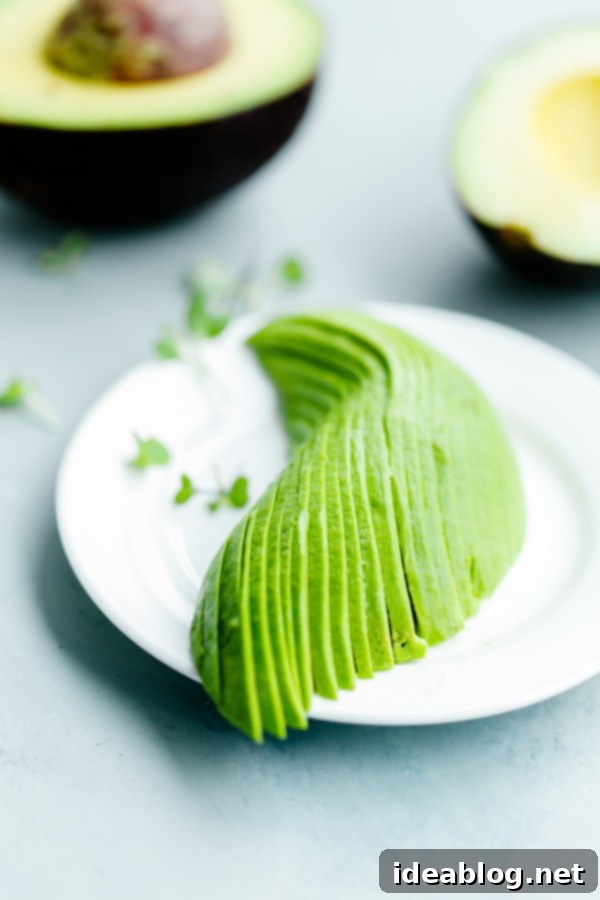Spicy Hummus Avocado Toast with Feta. An easy vegetarian snack with a spicy kick! #abeautifulplate #vegetarian #feta #hummus #toast #recipe #avocado Thinly sliced avocado fanned out on a piece of toast