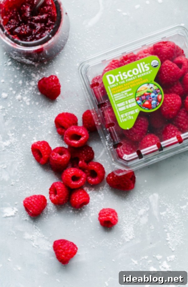 Raspberry roll cake – vanilla sponge roll cake filled with fresh raspberries, raspberry preserves, and vanilla whipped cream. This light summer cake recipe is a family favorite! #rollcake #spongecake #raspberry #abeautifulplate #recipe #dessert  Driscolls Organic Raspberries