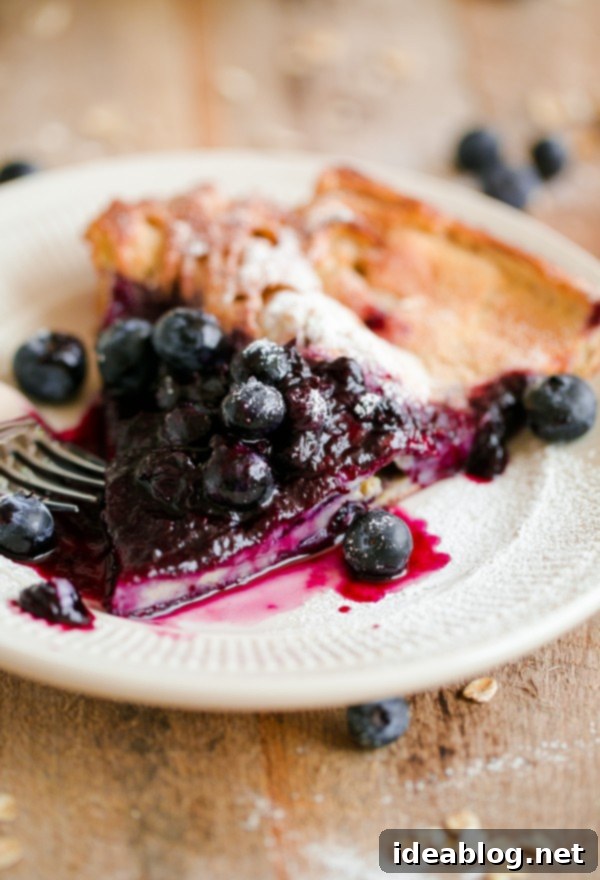 Delicious Gluten-Free Dutch Baby Slice, ideal for a hearty breakfast or elegant brunch A perfect slice of Gluten-Free Dutch Baby showcasing its soft, custardy interior and crispy edges