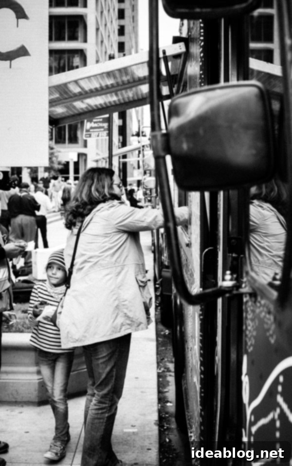 A vibrant scene of people and food trucks in the city, showcasing a lively street food event