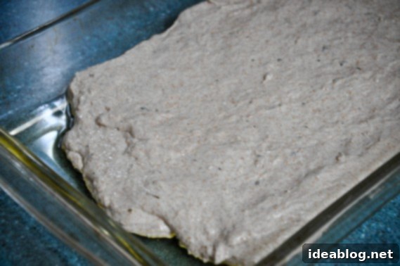 Rustic No-Knead Whole Wheat Cheesy Focaccia 5 Dough resting in the baking dish for Whole Wheat No-Knead Focaccia Bread