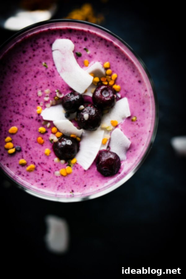 Simple Berry Smoothie - made with greek yogurt, frozen berries, coconut water, and my favorite smoothie addition: almond buttter.  Close-up of a refreshing simple berry smoothie in a mason jar, highlighting its thick, creamy texture and vibrant color, with ingredients like Greek yogurt and almond butter.