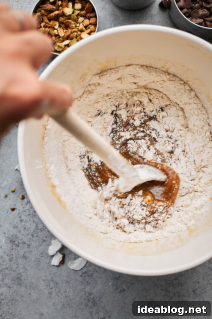 Effortless Blondies Endless Flavor Twists 6 Flour being gently folded into the blondie batter, ensuring not to overmix.