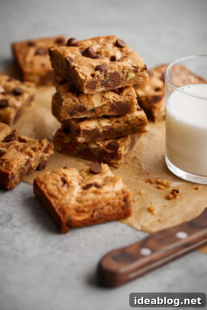 Effortless Blondies Endless Flavor Twists 10 Stack of freshly baked blondies beside a glass of milk, a perfect snack or dessert.