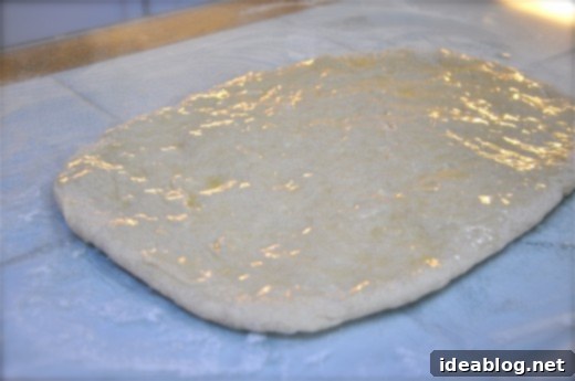 Easy No-Yeast Cinnamon Rolls 4 How to Make Cinnamon Rolls without Yeast - Dough being kneaded on a floured surface, showing the preparation for no-yeast cinnamon rolls.