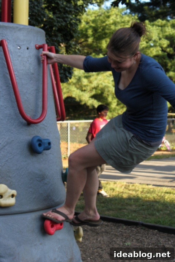 Crab Feast, Autumnal Pumpkins and Sweet Gelato Indulgence 8 A person posing triumphantly at the top of a small, outdoor climbing wall
