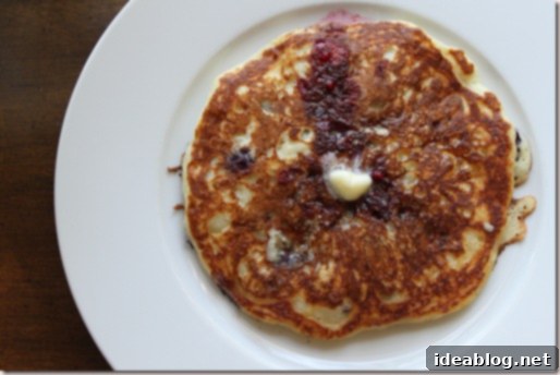 Wholesome Blueberry Quinoa Pancakes 2 Blueberry Quinoa Pancakes, stacked and drizzled with maple syrup