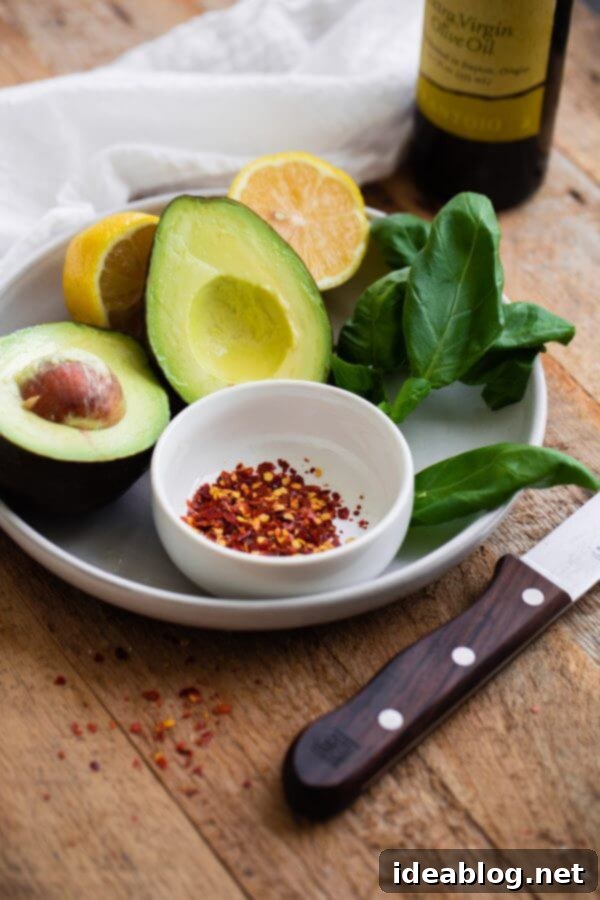 Fancy Avocado Toast - chunky avocado with lemon, chili flakes, basil - topped with a soft boiled egg!