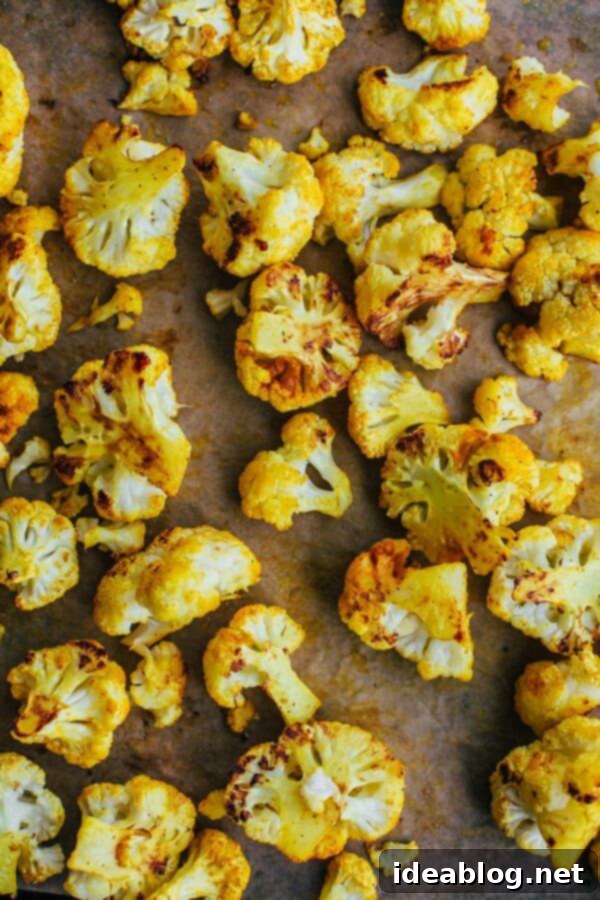 Velvety Roasted Cauliflower Soup: Coconut Turmeric Delight 3 Cauliflower florets tossed with turmeric and spices, ready for roasting