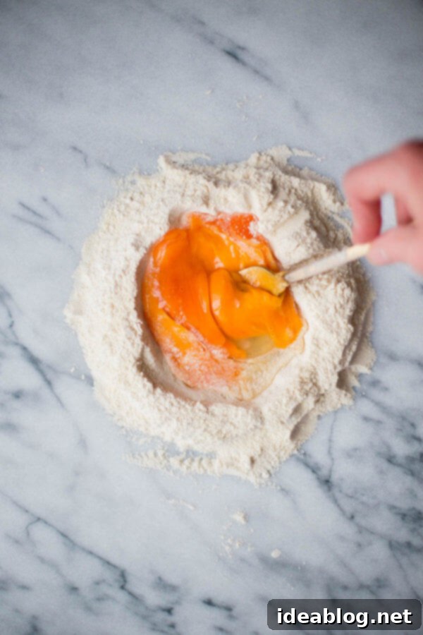 Homemade Pappardelle Pasta - a simple traditional egg pasta dough recipe made with all-purpose flour, semolina, and eggs! Made traditionally or naturally colored (pink!) with beet puree. #pasta #recipe #pappardelle #homemade #italian #abeautifulplate Homemade Pappardelle Pasta