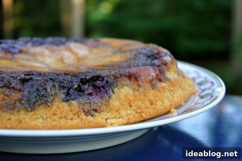 Golden Berry Peach Upside Down Skillet Cake 4 Slice of Upside Down Berry Peach Skillet Cake on a plate with vanilla ice cream