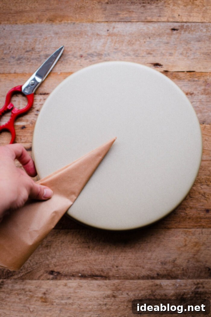 Flawless Cake Release: Parchment Lining Any Pan 9 A series of repeated folds creates a very small, pointed parchment triangle, ready for the final trimming.