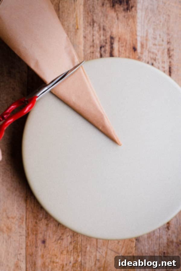 Flawless Cake Release: Parchment Lining Any Pan 10 The tip of the folded parchment triangle is aligned to the center of an inverted cake pan for accurate measurement.