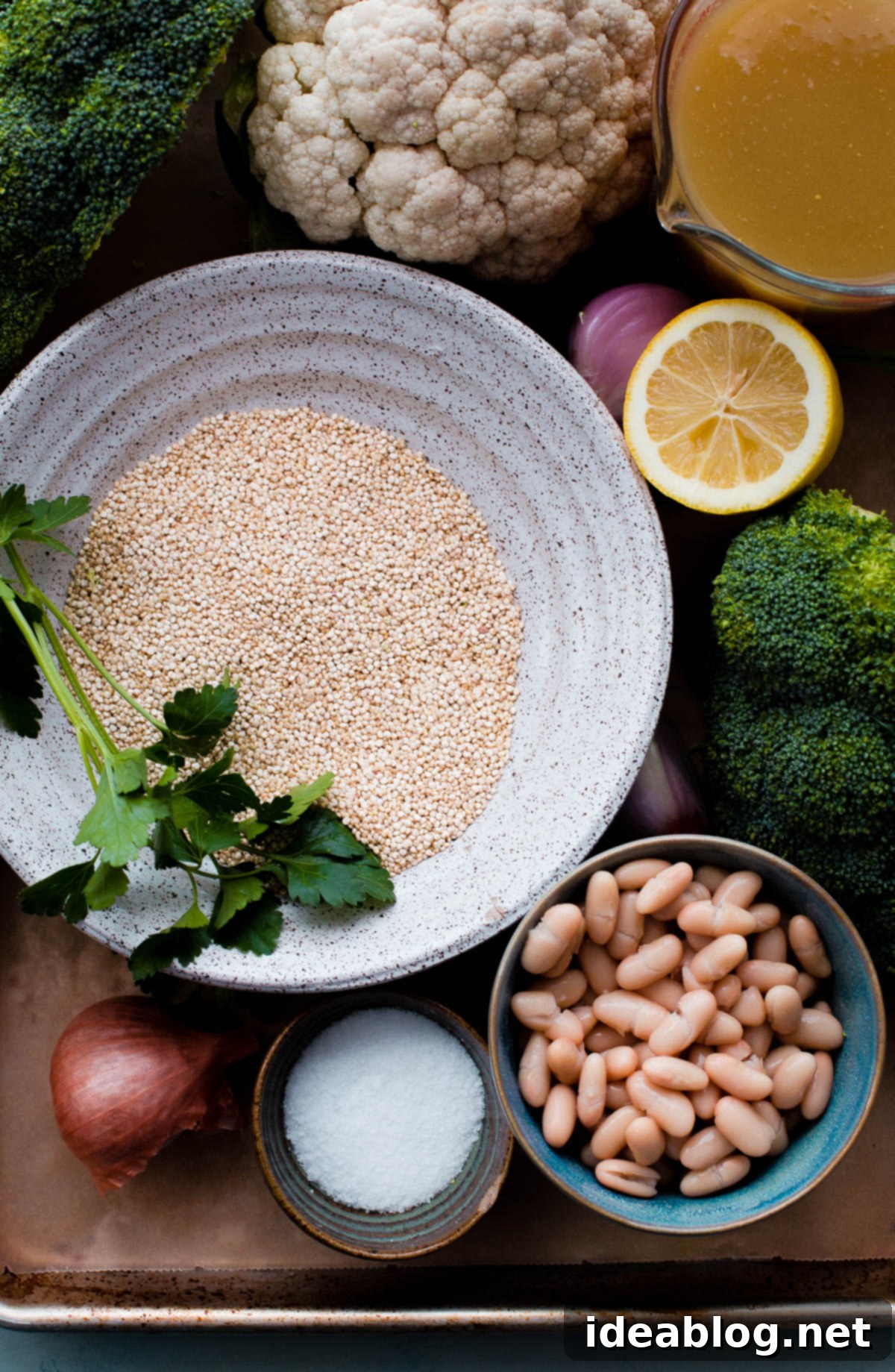Key ingredients for a creamy and healthy quinoa risotto, featuring white beans for a dairy-free texture. Ingredients for Quinoa Risotto