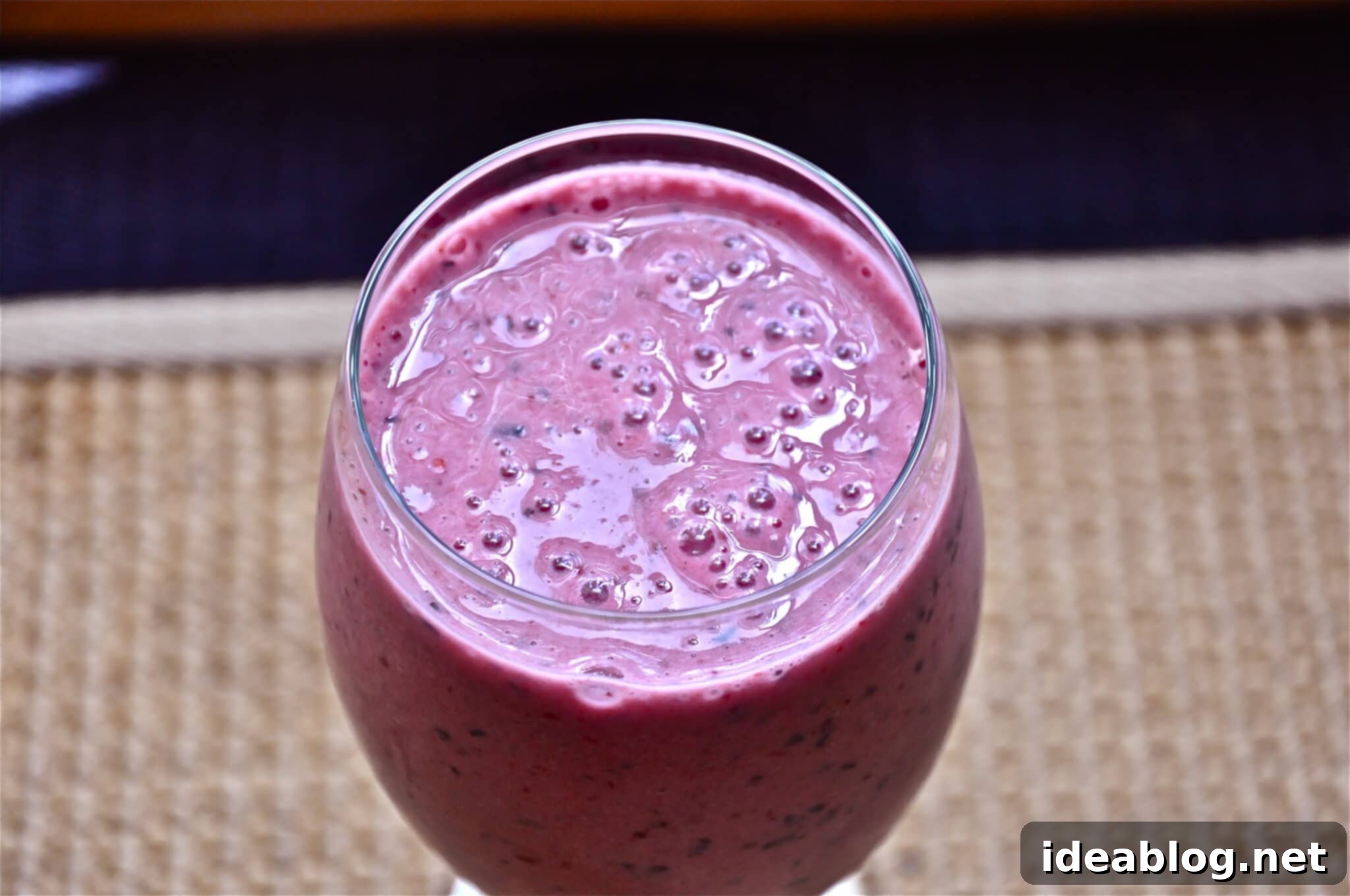 Sun-Kissed Berry Peach Smoothie 2 Summertime Berry Peach Smoothie in a tall glass, garnished with fresh berries