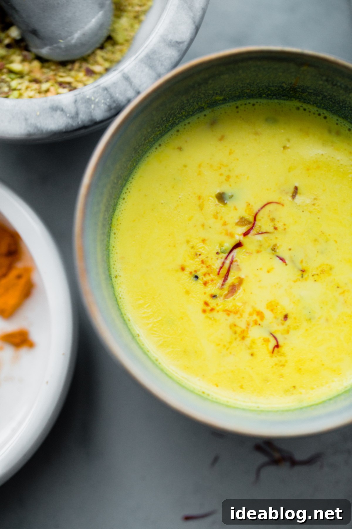 Turmeric Almond Milk - a lightly sweetened warm drink made from turmeric, almonds, and milk and infused with saffron and cardamom! Turmeric Almond Milk