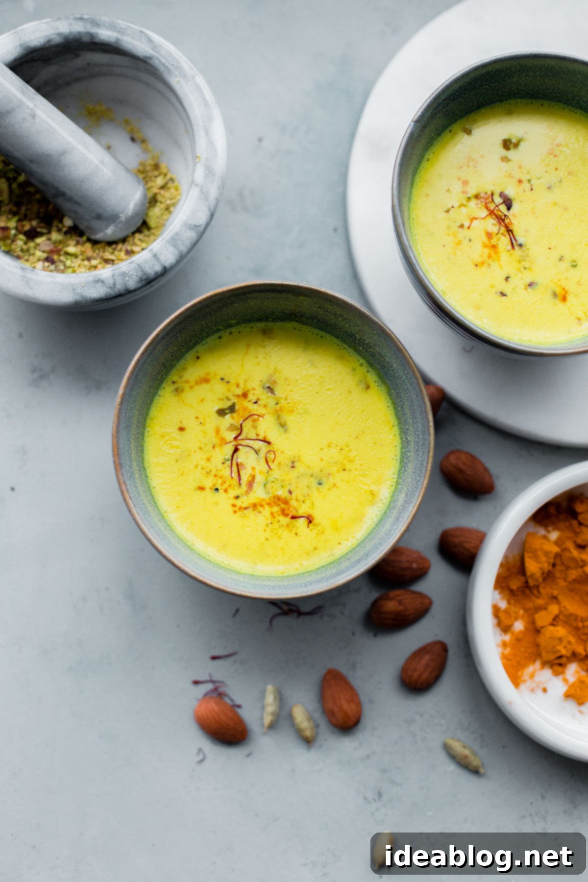 Turmeric Almond Milk - a lightly sweetened warm drink made from turmeric, almonds, and milk and infused with saffron and cardamom! Turmeric Almond Milk