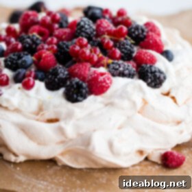 Luscious Berry Pavlova with Zesty Lemon Cream 2 Delicious and Easy Lemon Berry Pavlova Recipe - this delicious pavlova is filled with lemon whipped cream and fresh berries!