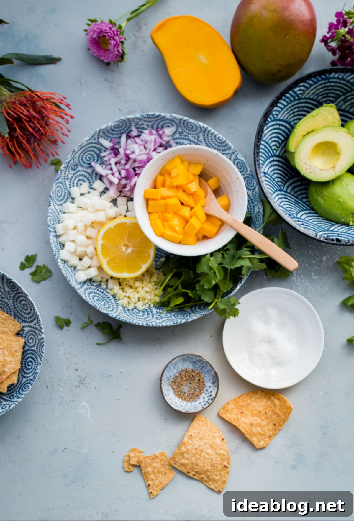 Delicious Tropical Mango Guacamole artfully arranged in a rustic bowl, showcasing its chunky texture and colorful ingredients. A bowl of vibrant Tropical Mango Guacamole, generously garnished with fresh cilantro and reserved mango pieces, ready to be served.