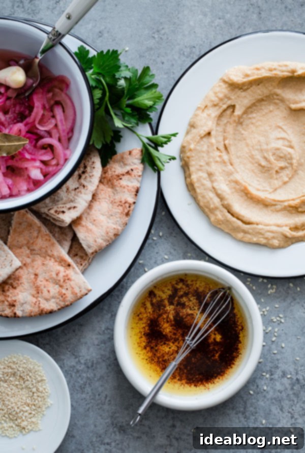 Gourmet Hummus with Jammy Egg and Sumac Kissed Onions 3 Pita with Pickled Onions and Hummus