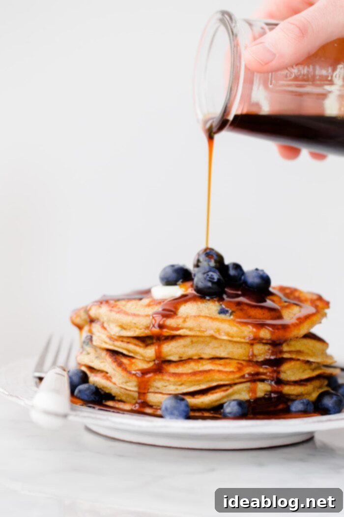 18 Scrumptious Brunch Recipes to Make Mom Smile 7 Stack of fluffy Blueberry Rye Pancakes drizzled with molasses syrup