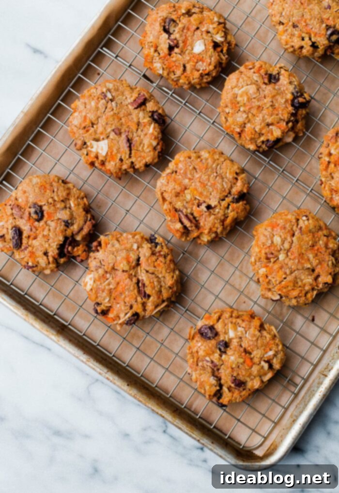 18 Scrumptious Brunch Recipes to Make Mom Smile 8 Carrot Cake Breakfast Cookies with frosting swirls on a cooling rack