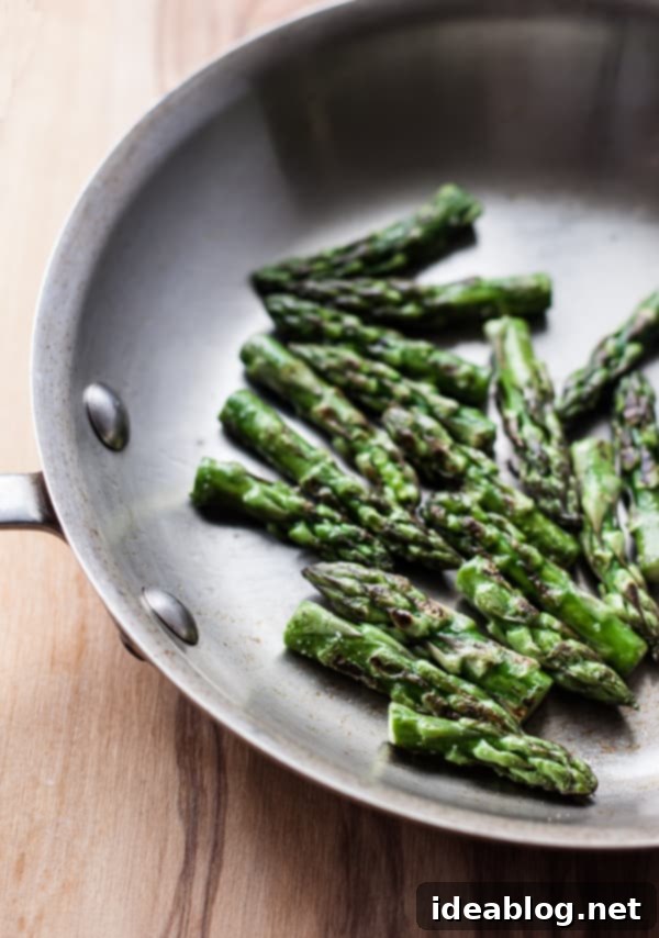 Your Perfect Asparagus Cooking Guide 5 Sautéed Asparagus Tips in Pan with garlic