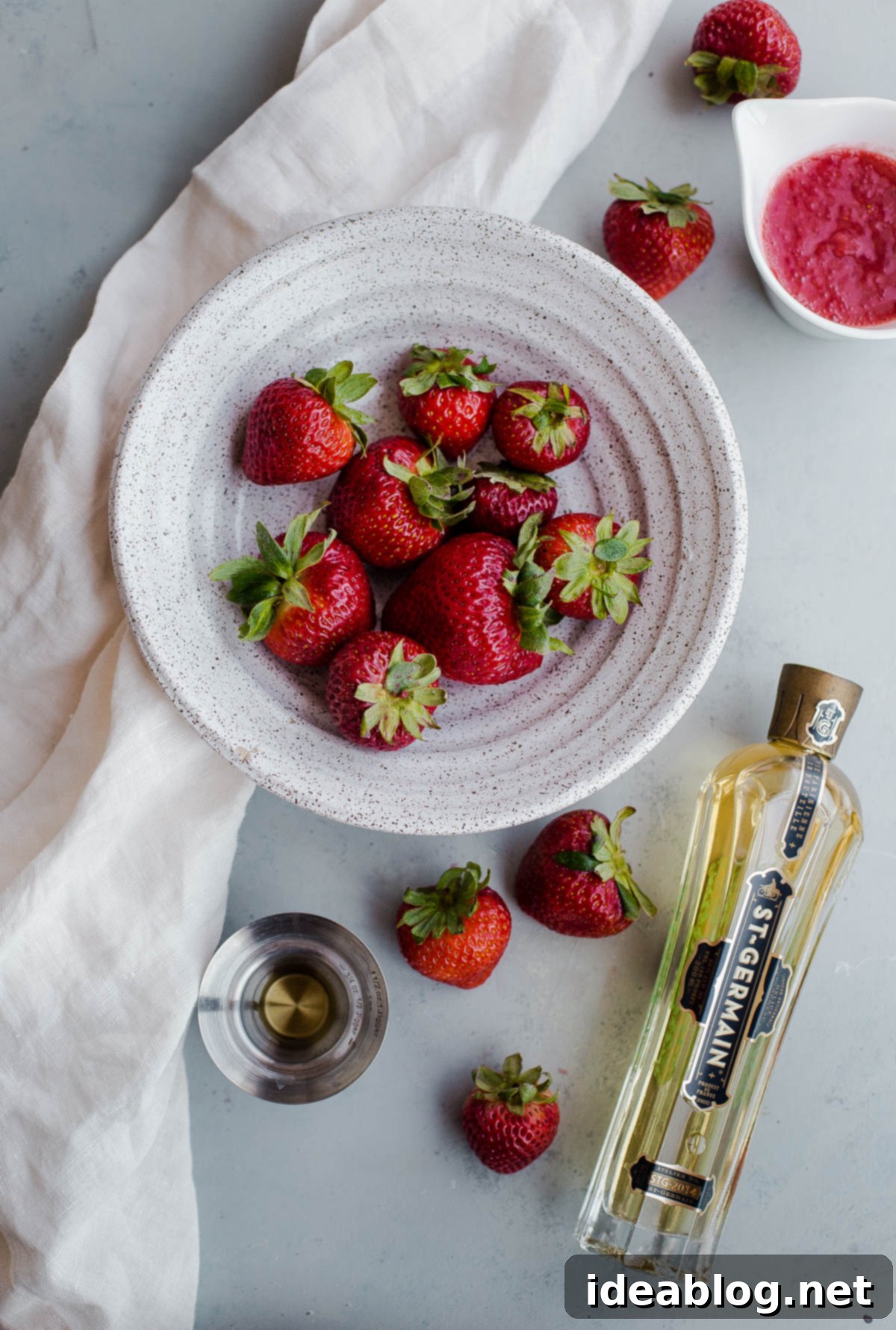 Strawberry Elderflower Sparkler - a refreshing summer prosecco cocktail infused with fresh strawberry puree, elderflower liqueur, and vodka. St.Germain elderflower liqueur, fresh strawberries, and prosecco ingredients for a sparkling cocktail