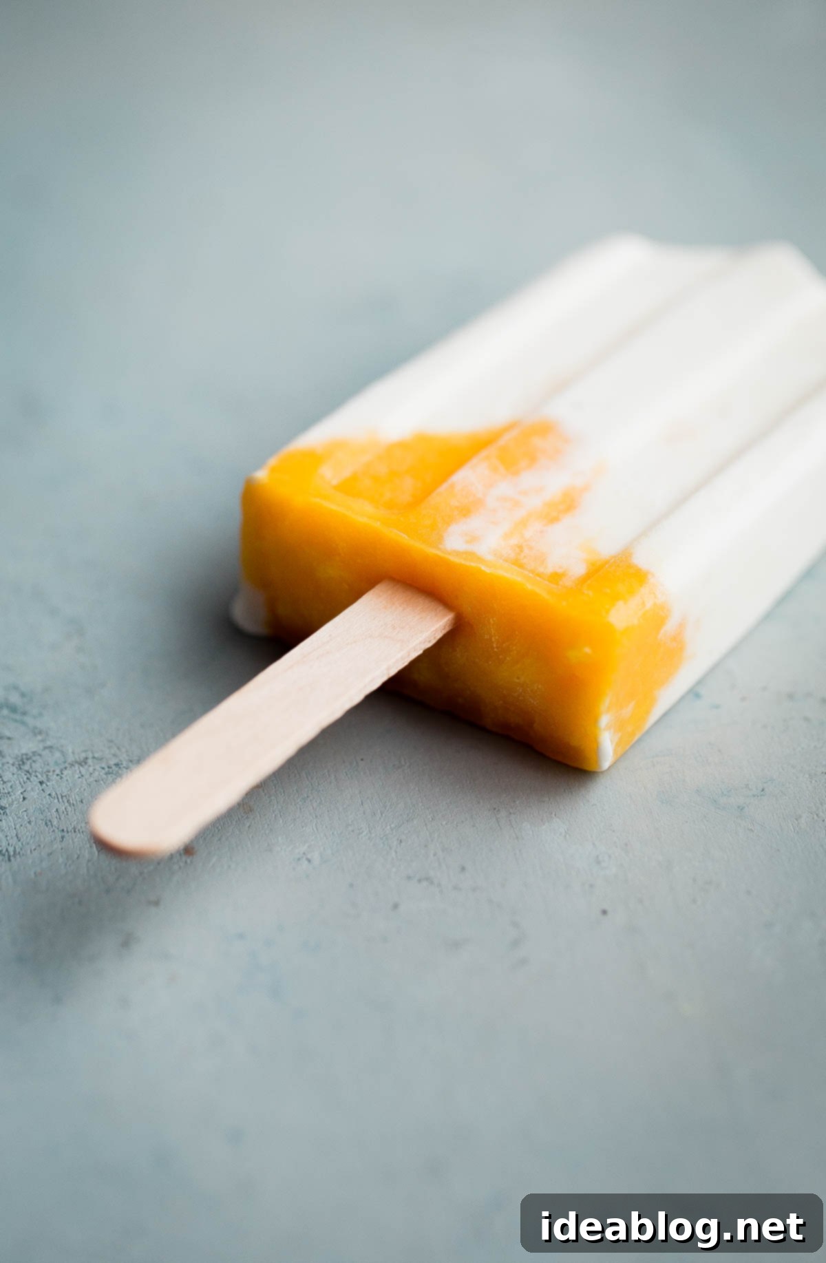 Sunshine Mango Lassi Pops 2 Healthy homemade mango lassi popsicles made with Greek yogurt, coconut milk, and fresh mango. Perfect for summer and naturally sweetened.