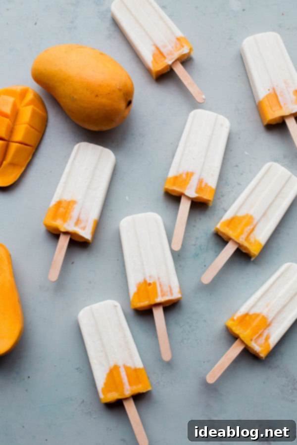 Sunshine Mango Lassi Pops 4 Two healthy mango lassi popsicles, highlighting their creamy texture and natural sweetness from mango and yogurt.