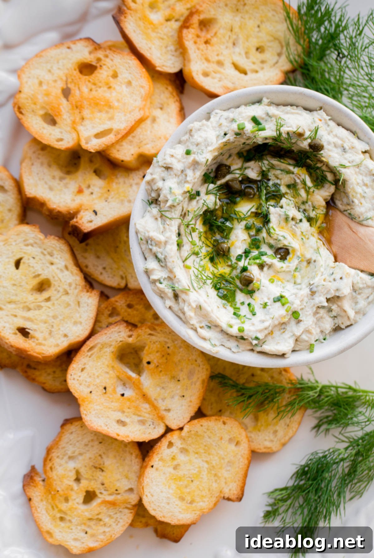 Perfect Tuna Crostini - easy, herbaceous tuna spread on crisp baguette slices Delicious Tuna Crostini ready to be served on an Italian antipasto platter.