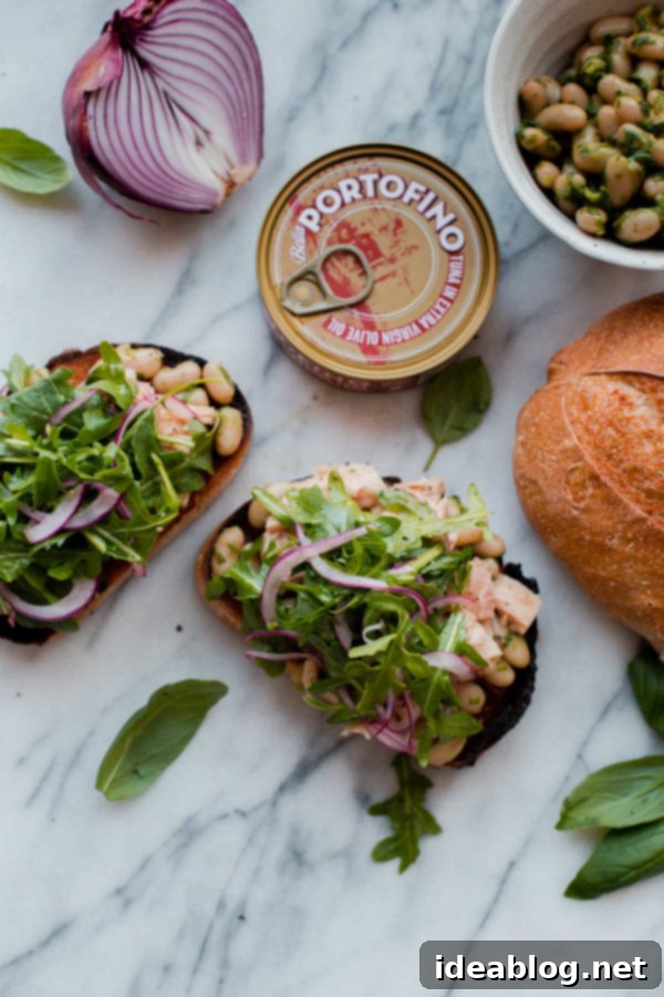 Mediterranean Tuna Sandwich - a modern, fresh and dairy free Italian tuna sandwich made with pesto cannellini beans, olive oil packed Albacore tuna, and peppery arugula! #abeautifulplate #tunafish #sandwich #dairyfree #recipe #easyrecipes #italian Mediterranean Tuna Sandwiches