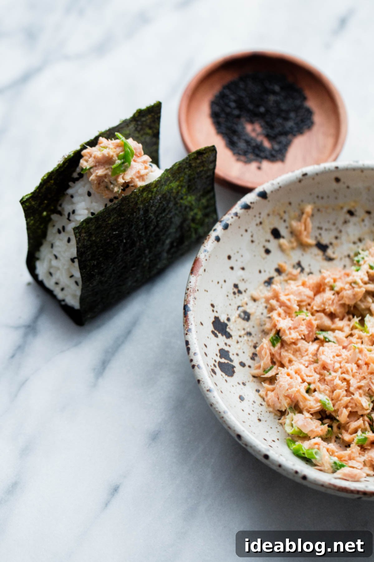 Spicy Tuna Onigiri 2 Homemade Spicy Tuna Onigiri - traditional Japanese rice balls with a delicious spicy tuna filling made with Bella Portofino olive oil packed tuna, mayonnaise, sriracha, scallions, and rice vinegar.